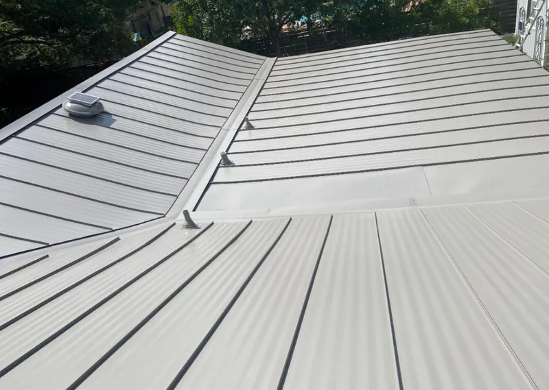 Solar attic fan installed on a metal roof for Roof Ventilation in Bainbridge